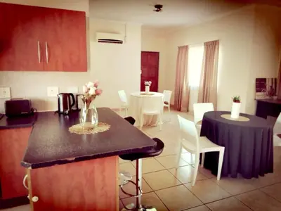 a kitchen and dining room with a table and chairs at Vutomi Guesthouse in Burgersfort