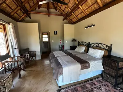 a bedroom with a large bed in a room at Mokaikai - Leopards Leap - Moi Exclusive Luxury Villa in Mabula