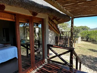 a porch of a house with a view of the yard at Mokaikai - Leopards Leap - Moi Exclusive Luxury Villa in Mabula