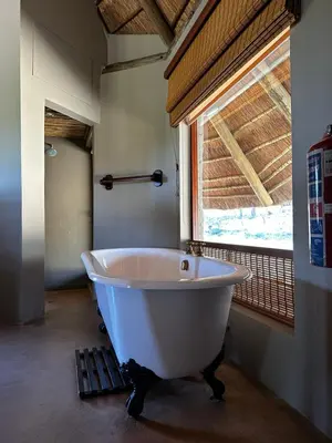 a white bath tub in a bathroom with a window at Mokaikai - Leopards Leap - Moi Exclusive Luxury Villa in Mabula