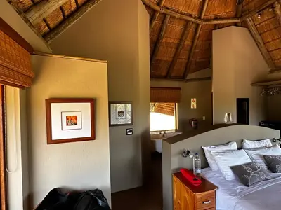 a bedroom with a bed and a wooden ceiling at Mokaikai - Leopards Leap - Moi Exclusive Luxury Villa in Mabula