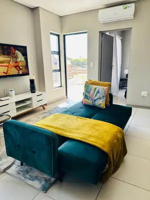 a bedroom with a large bed and a tv at Centurion Marnard Luxury Apt in Centurion