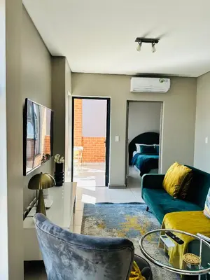 a living room with a couch and a tv at Centurion Marnard Luxury Apt in Centurion