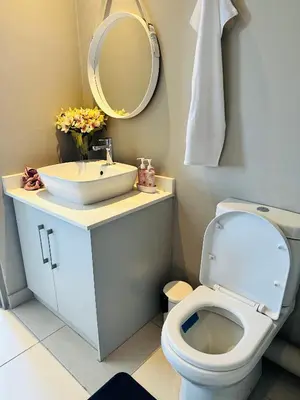 a bathroom with a toilet and a sink and a mirror at Centurion Marnard Luxury Apt in Centurion