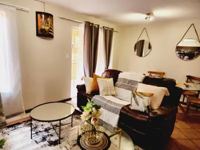 a living room with a couch and a table at Beagle Sands in Pretoria