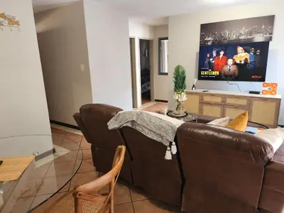 a living room with a couch and a flat screen tv at Beagle Sands in Pretoria