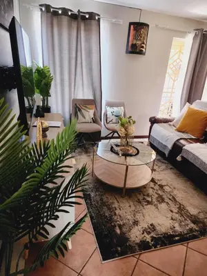 a living room with a couch and a table at Beagle Sands in Pretoria