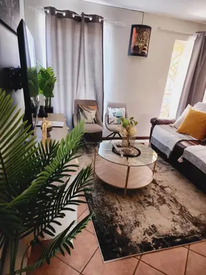 a living room with a couch and a table at Beagle Sands in Pretoria