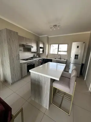 a kitchen with a large white island in the middle at Tranquility in Carlswald in Midrand