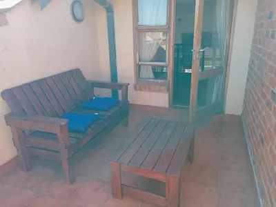 a wooden bench sitting in a room with a window at Calswald's Skyline Sanctuary in Midrand
