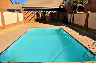 an empty swimming pool in the yard of a house at Calswald's Skyline Sanctuary in Midrand