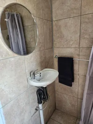 a bathroom with a sink and a mirror at khutsong Apartments in Secunda
