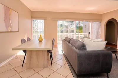 a living room with a couch and a table at Cozy Apartment close to Menlyn in Pretoria