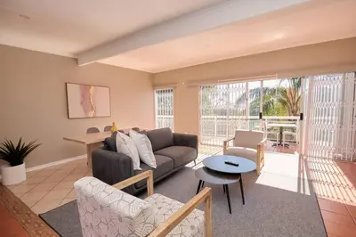 a living room with a couch and a table at Cozy Apartment close to Menlyn in Pretoria