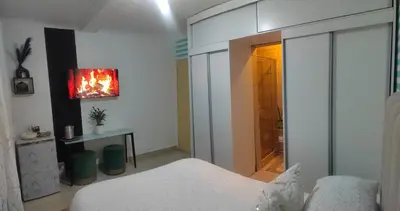 a bedroom with a bed and a fireplace in it at Palma spaces in Pretoria