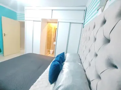 a bedroom with a bed with blue pillows on it at Palma spaces in Pretoria