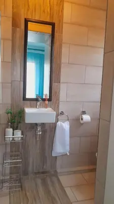 a bathroom with a sink and a mirror at Palma spaces in Pretoria