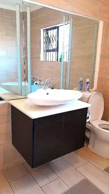 a bathroom with a sink and a toilet at Palma spaces in Pretoria