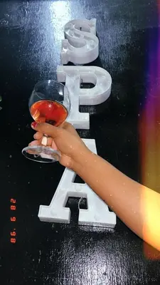 a person holding a wine glass with the letter e at Mantombi's Guest House in Graskop