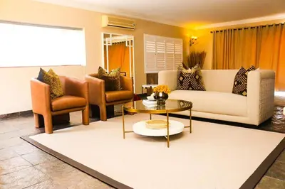 a living room with a couch and a table and chairs at Keleo Safari Lodge in Bela-Bela
