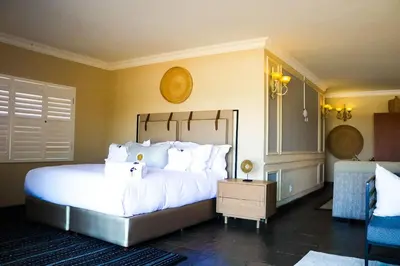 a bedroom with a large bed with white pillows at Keleo Safari Lodge in Bela-Bela