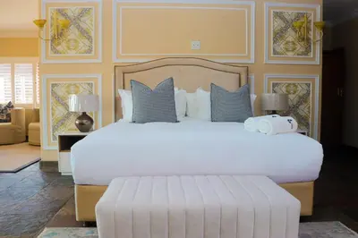 a bedroom with a large white bed with pillows at Keleo Safari Lodge in Bela-Bela