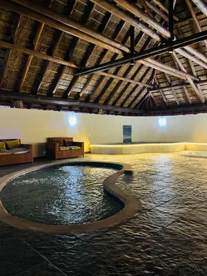a pool in the middle of a room with a ceiling at Keleo Safari Lodge in Bela-Bela