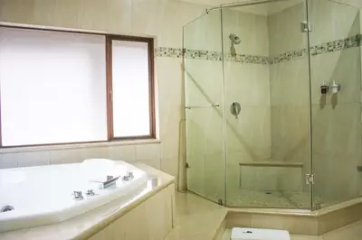 a bathroom with a glass shower and a sink at Keleo Safari Lodge in Bela-Bela