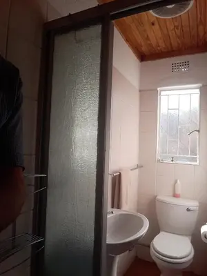 a bathroom with a toilet and a sink at Luilekker Chalets in Waterval-Onder