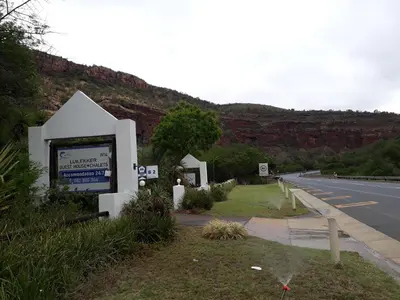 a sign on the side of a road at Luilekker Chalets in Waterval-Onder