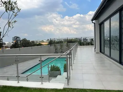 a balcony of a house with a swimming pool at The Pebbles in Midrand