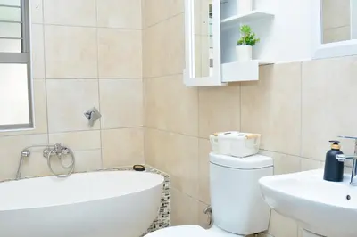 a bathroom with a white toilet and a sink at Home for Us Self catering in Duvhapark