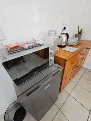 a kitchen with an oven and a wooden counter at De Villa Guesthouse in Middelburg
