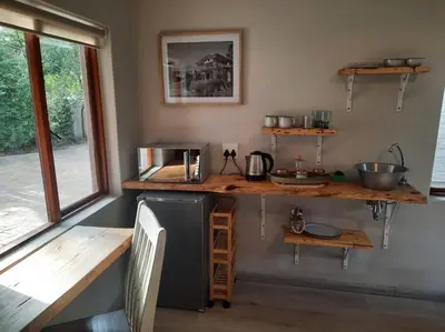 a kitchen with a counter and a refrigerator in a room at Nel's Studio in Benoni