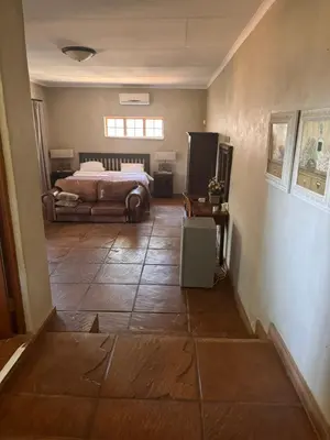 a bedroom with a bed and a tiled floor at Joes Country lodge in White River