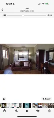 a screenshot of a room with a bed and a piano at Joes Country lodge in White River