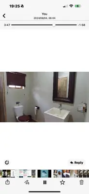 a bathroom with a sink and a toilet and a mirror at Joes Country lodge in White River