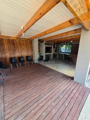 a large room with a wooden floor and chairs at Impala Palms Guesthouse in Modimolle
