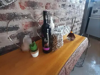 a bottle of wine sitting on top of a table at The Hedgehog at Marloth Park in Marloth Park