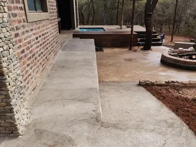 a concrete sidewalk next to a brick building at The Hedgehog at Marloth Park in Marloth Park