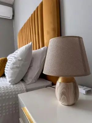 a lamp on a table next to a bed at AndriMat Villa Harties in Hartbeespoort