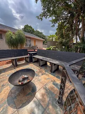 a picnic table and a grill next to a bench at AndriMat Villa Harties in Hartbeespoort