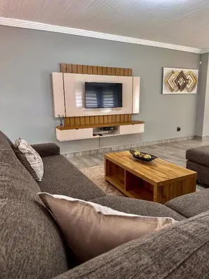 a living room with a couch and a coffee table at AndriMat Villa Harties in Hartbeespoort