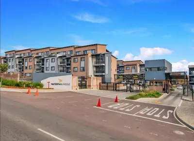an empty parking lot in front of a building at The Ridge View in Midrand