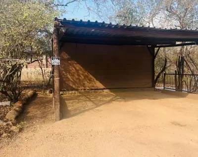 a shed with a sign in front of it at Vivo Per Lei - Marloth Park in Marloth Park