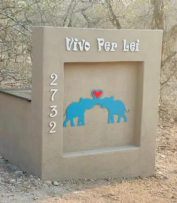 a sign with two elephants and a heart at Vivo Per Lei - Marloth Park in Marloth Park