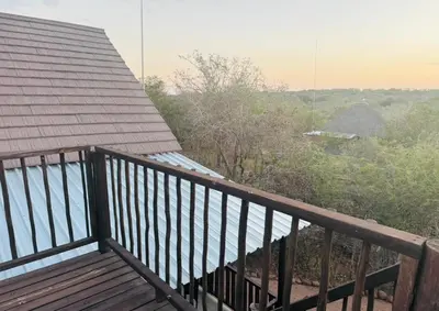 a balcony with a view of the water at Vivo Per Lei - Marloth Park in Marloth Park