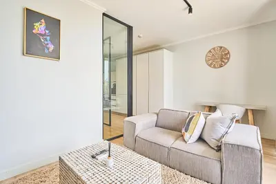 a living room with a couch and a table at 8's at Ellipse Waterfall in Midrand