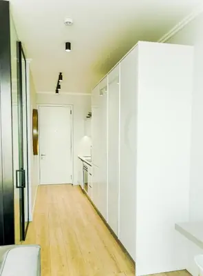 a room with white walls and a hallway with a door at 8's at Ellipse Waterfall in Midrand