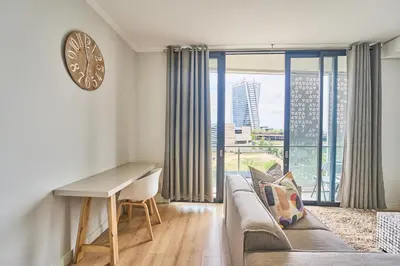 a living room with a couch and a desk at 8's at Ellipse Waterfall in Midrand